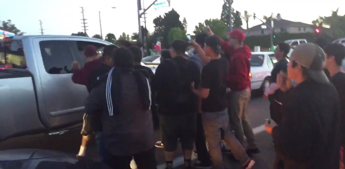 Protesters attack car outside of Trump rally in Costa Mesa, CA.