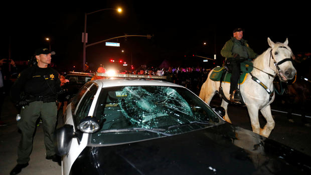 Cop car smashed by protesters outside of Costa Mesa, CA rally.